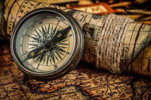 Old vintage compass on ancient map