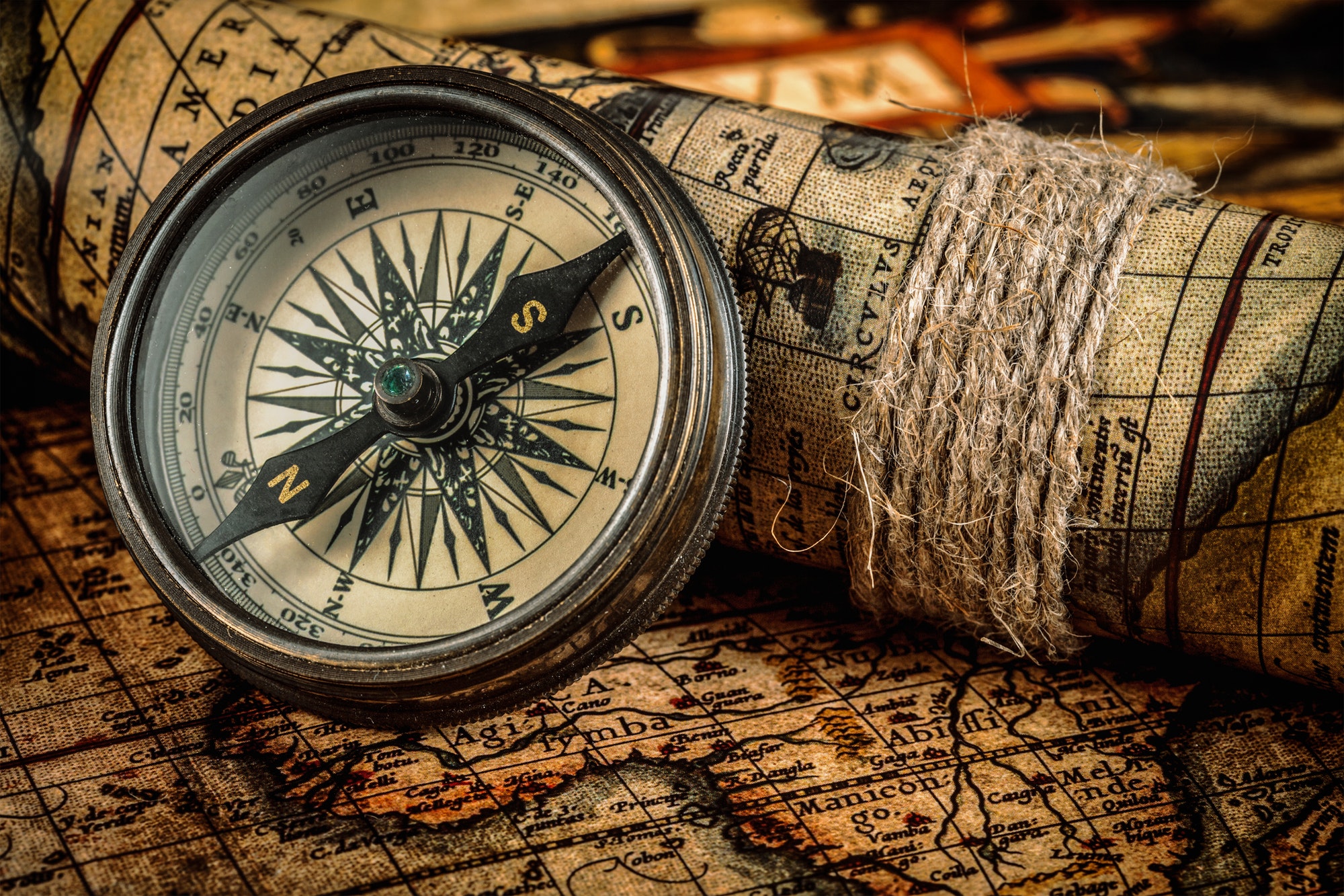 Old vintage compass on ancient map
