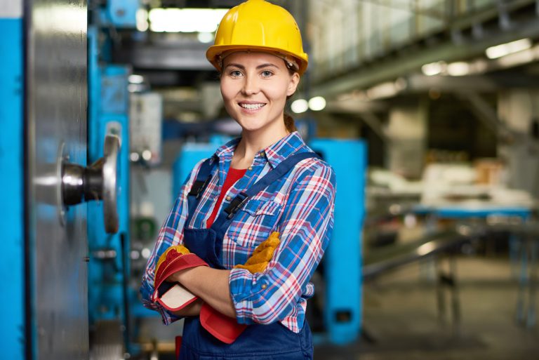 Happy Young Woman Working at Factory