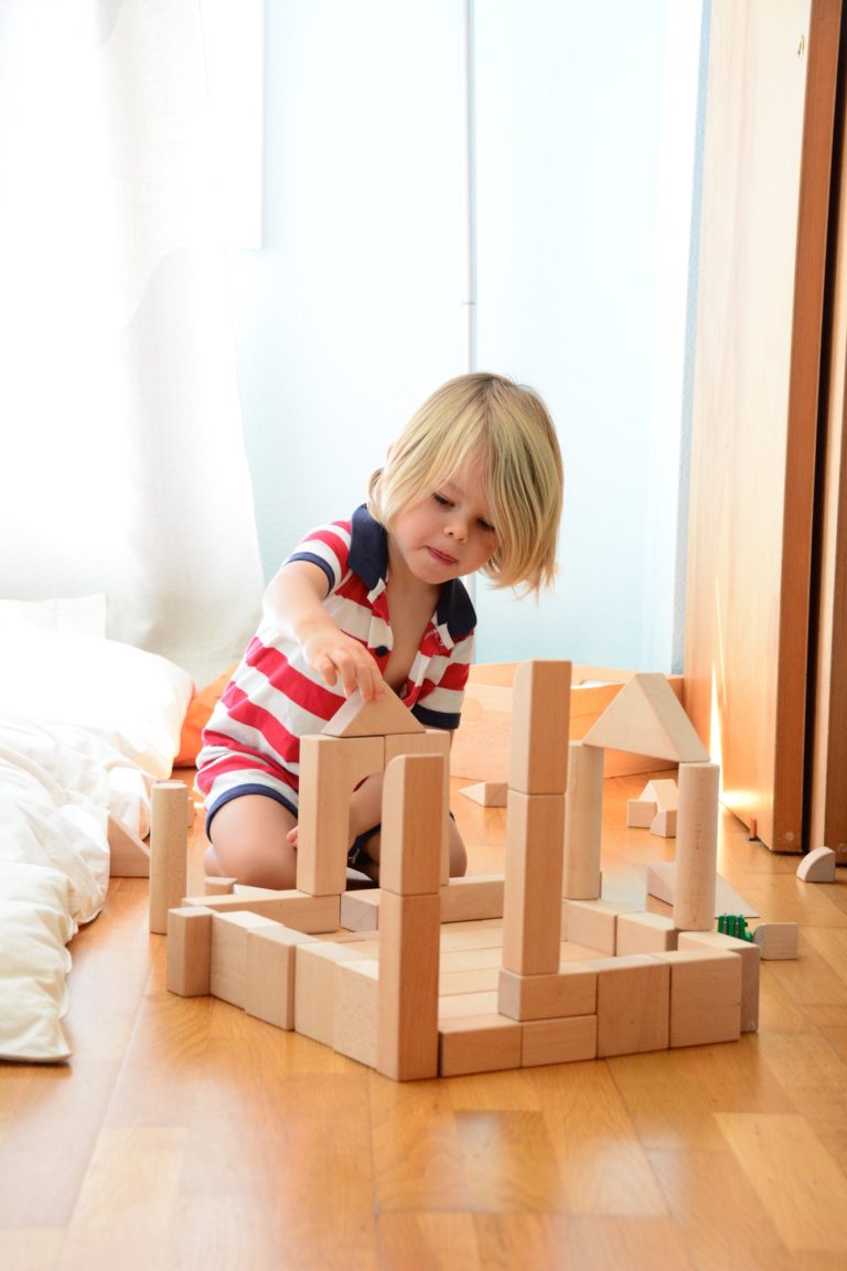 Boy playing with wooden blocks