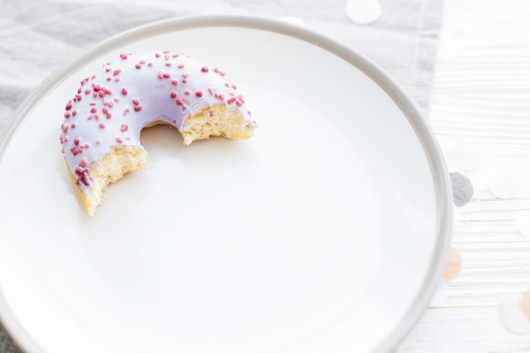 Delicious bite of donut with sprinkles