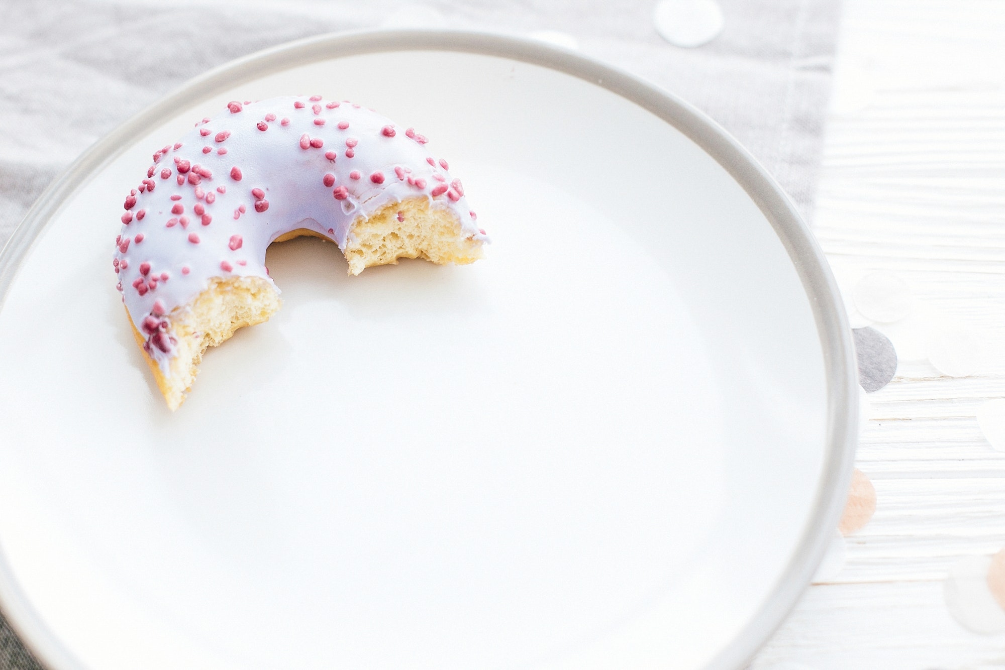 Delicious bite of donut with sprinkles